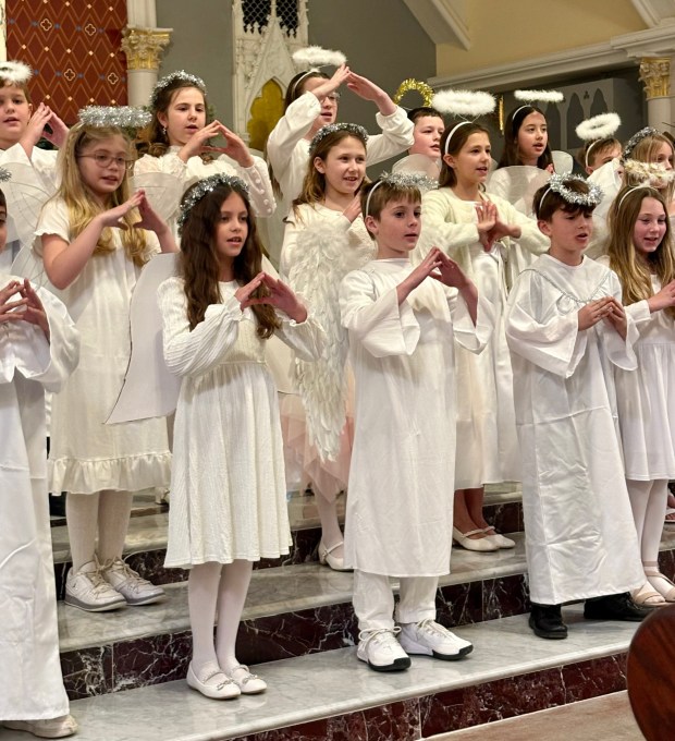 Angels watch over the manger during the Nativity program at St. Teresa of Calcutta Church. (Submitted Photo)