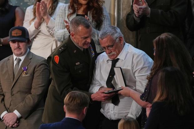 Evalea and Gary Beckstrom, the mother and father of National Guard member Sarah Beckstrom, receive a Purple Heart on behalf of their daughter