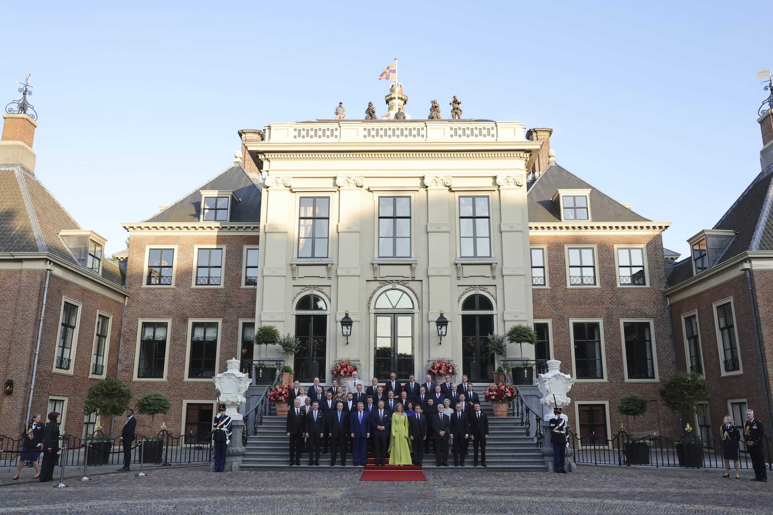 NATO heads of state and government pose for a group...