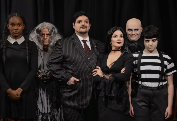Six actors in Addams Family costumes