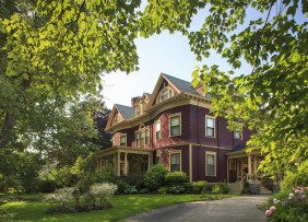 Large brick house with landscaped yard, big trees, and front and side porches Large brick house with landscaped yard, big trees, and front and side porches