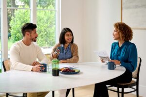 Couple sitting at table with real estate agent