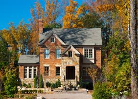 Brick house in wooded lot in autumn Brick house in wooded lot in autumn