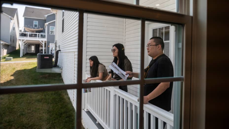 Prospective home buyers look from the balcony of a home for sale during an Open House in a neighborhood in Clarksburg, Maryland on September 3, 2023. Homeownership feels increasingly out of reach for younger generations of Americans, who are squeezed by student debt and childcare costs in an era of slower economic growth. The pressures come as President Joe Biden struggles to tackle negative sentiment about his handling of the economy, as he campaigns for re-election. (Photo by ROBERTO SCHMIDT / AFP) (Photo