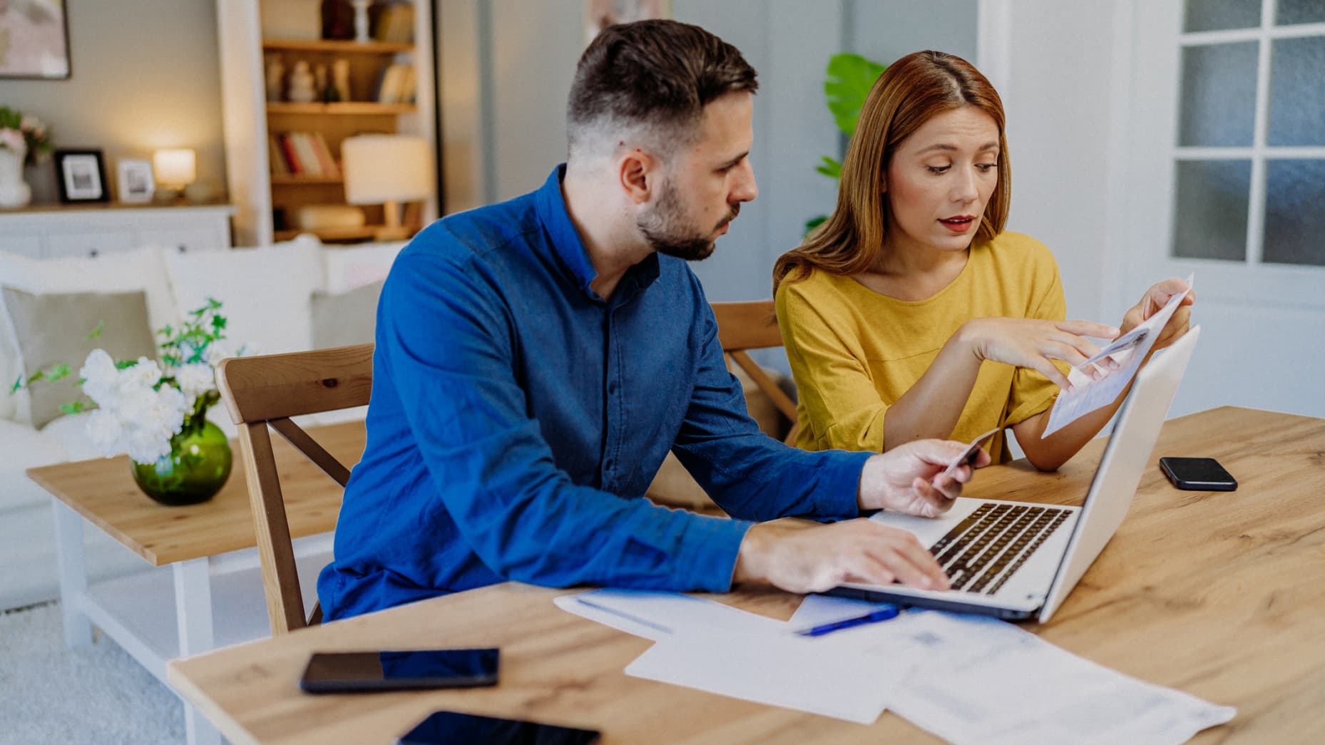 Young couple paying bills online.