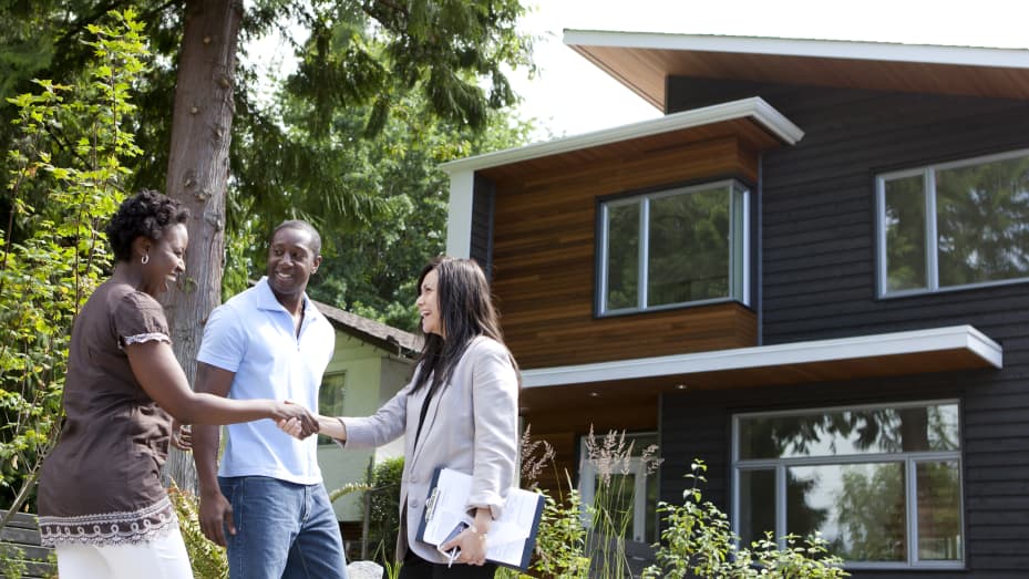 Black couple greet realtor at house for sale
